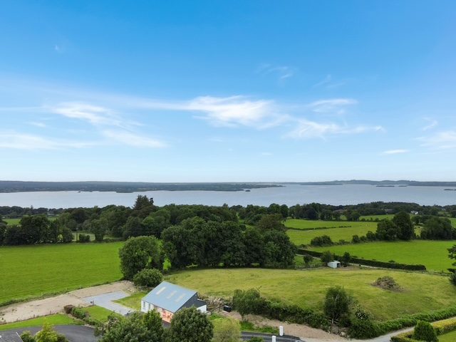 Aerial view of The Stables with Lough Derg beyond the fields