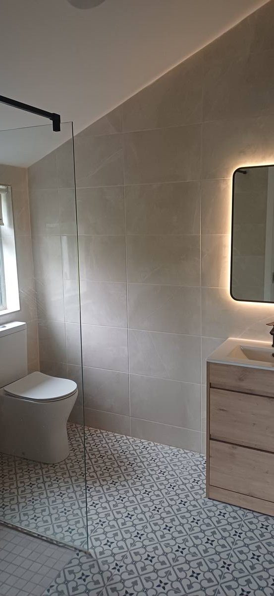 Wet room bathroom with patterned tile floor